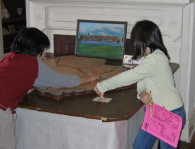 These children are examining a lighted map table along the History Hunt route at the Amherst County Museum