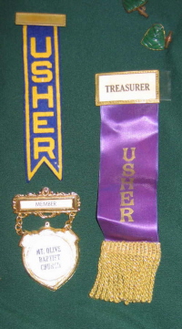 Lapel pins and ribbons were worn by ushers and many of the church officers.